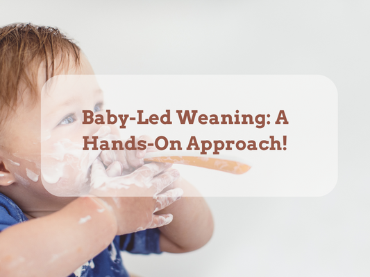 Adorable baby happily self-feeding with a spoon, exploring baby-led weaning with curiosity and joy.