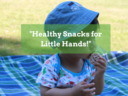 miling toddler holding a homemade organic snack, featured image for article on easy and healthy baby snacks for ages 6 months and up