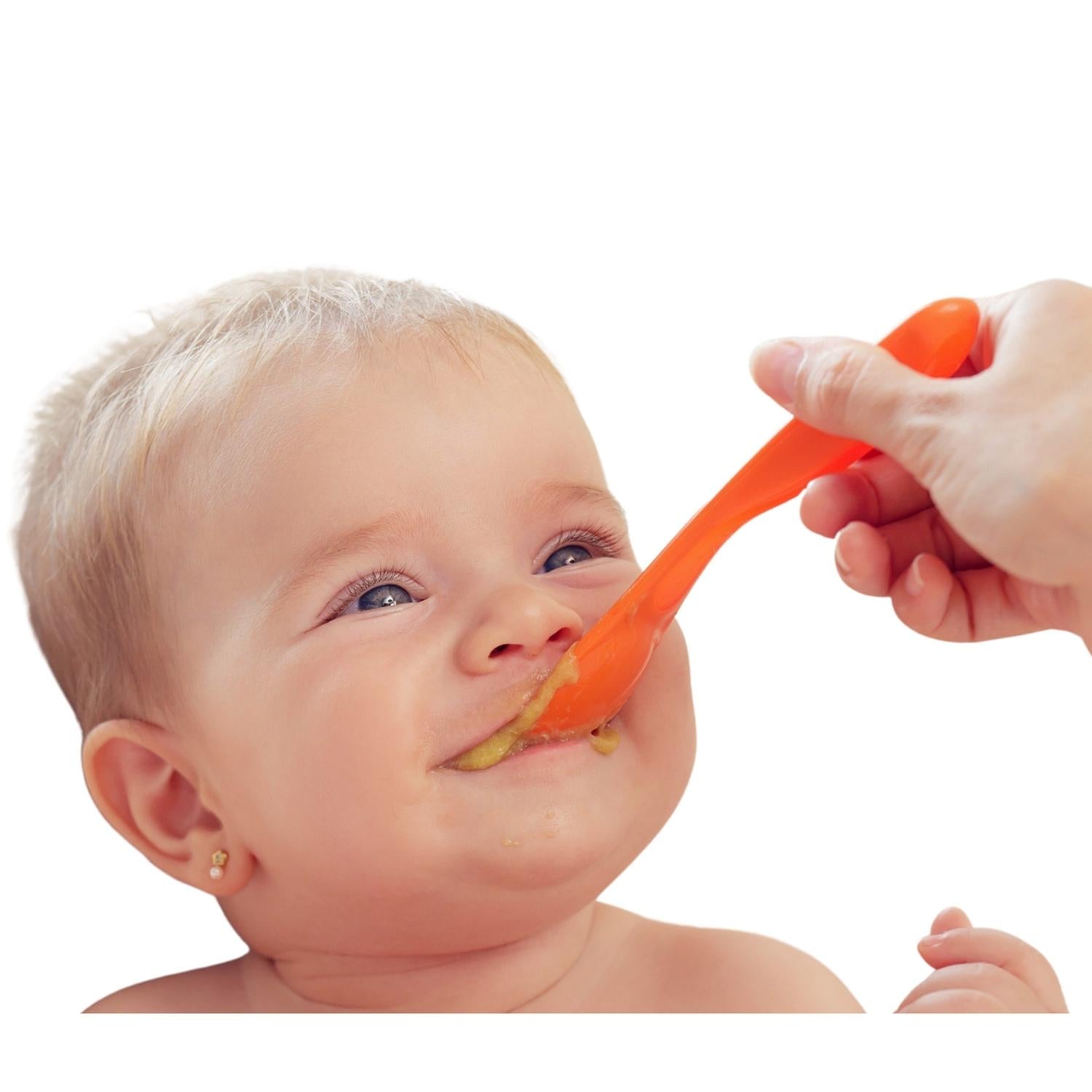Beautiful smiling Caucasian baby enjoying Baby Likes baby food, with a spoon gently touching her mouth during mealtime